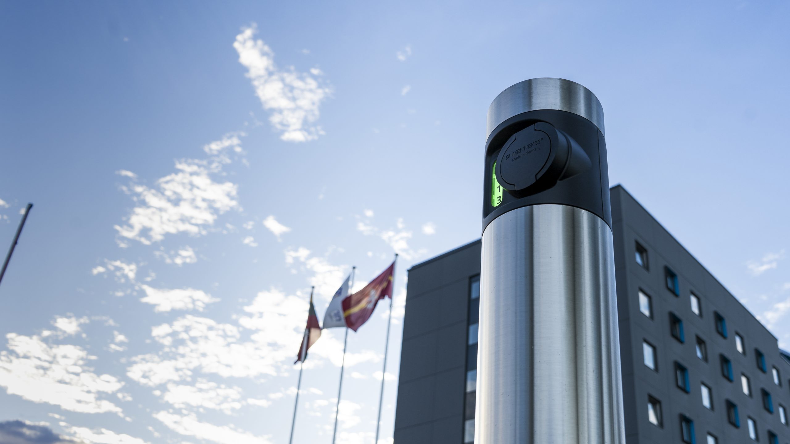 Inbalance grid charging station next to hotel building